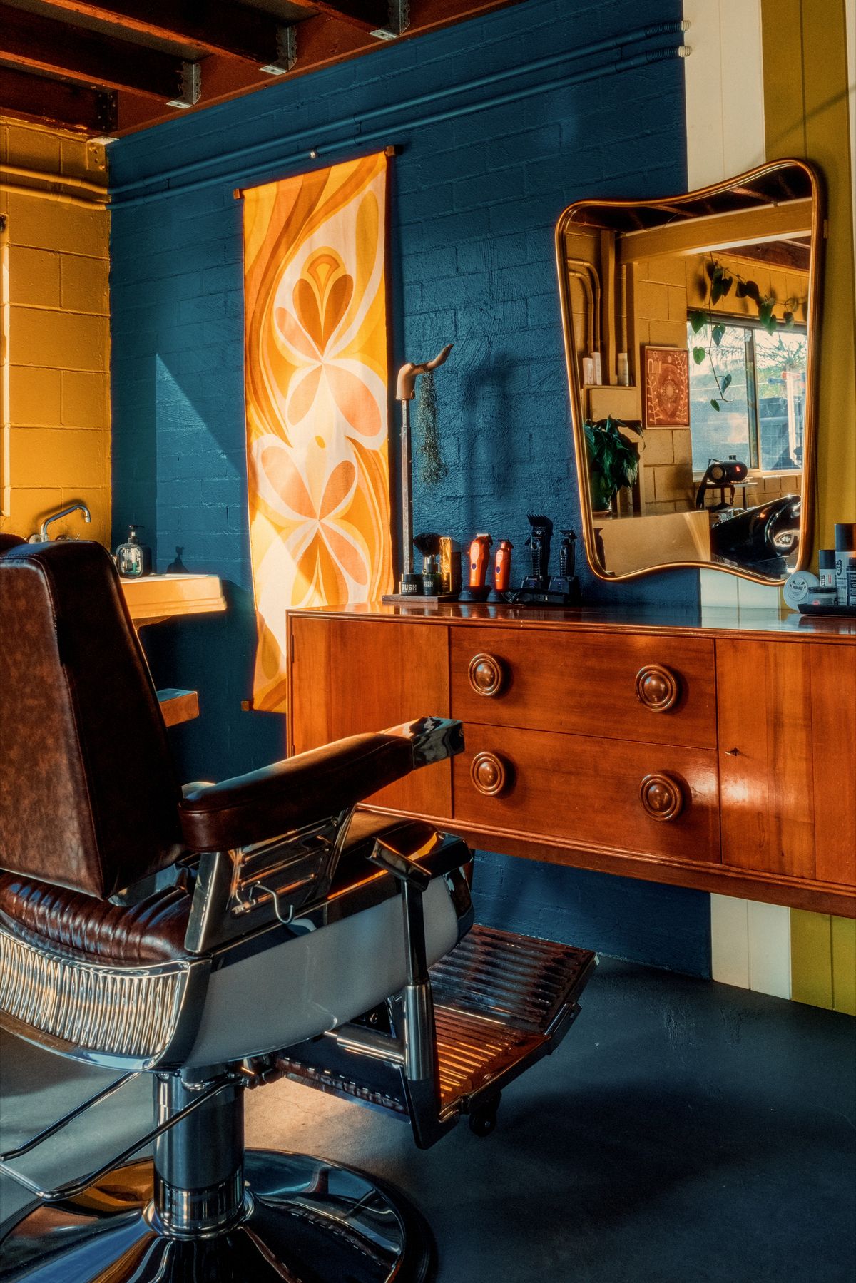 Vintage barber chair, mirror and mid-century dresser inside the Spunk studio