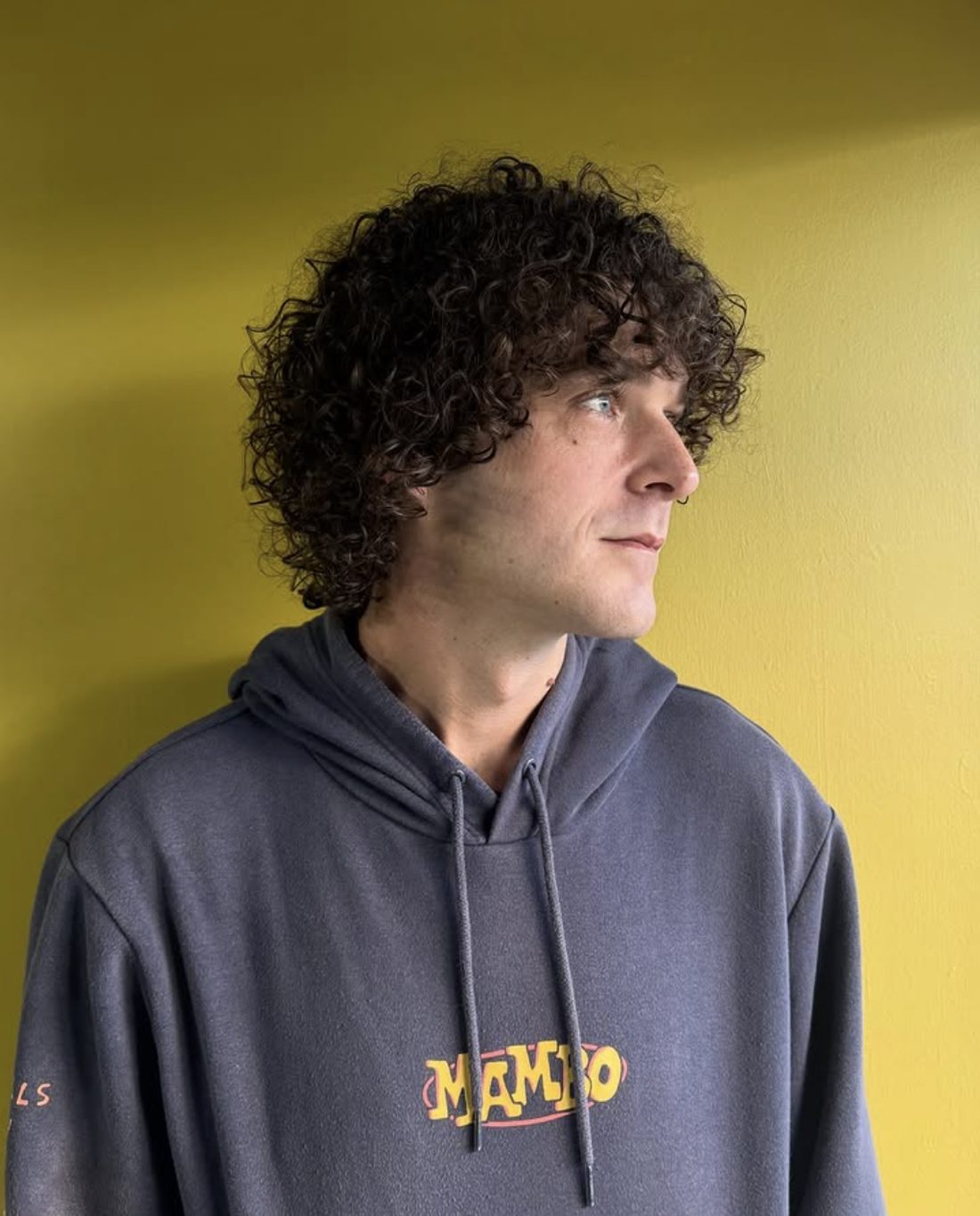 Client with voluminous curly hair, styled at Spunk
